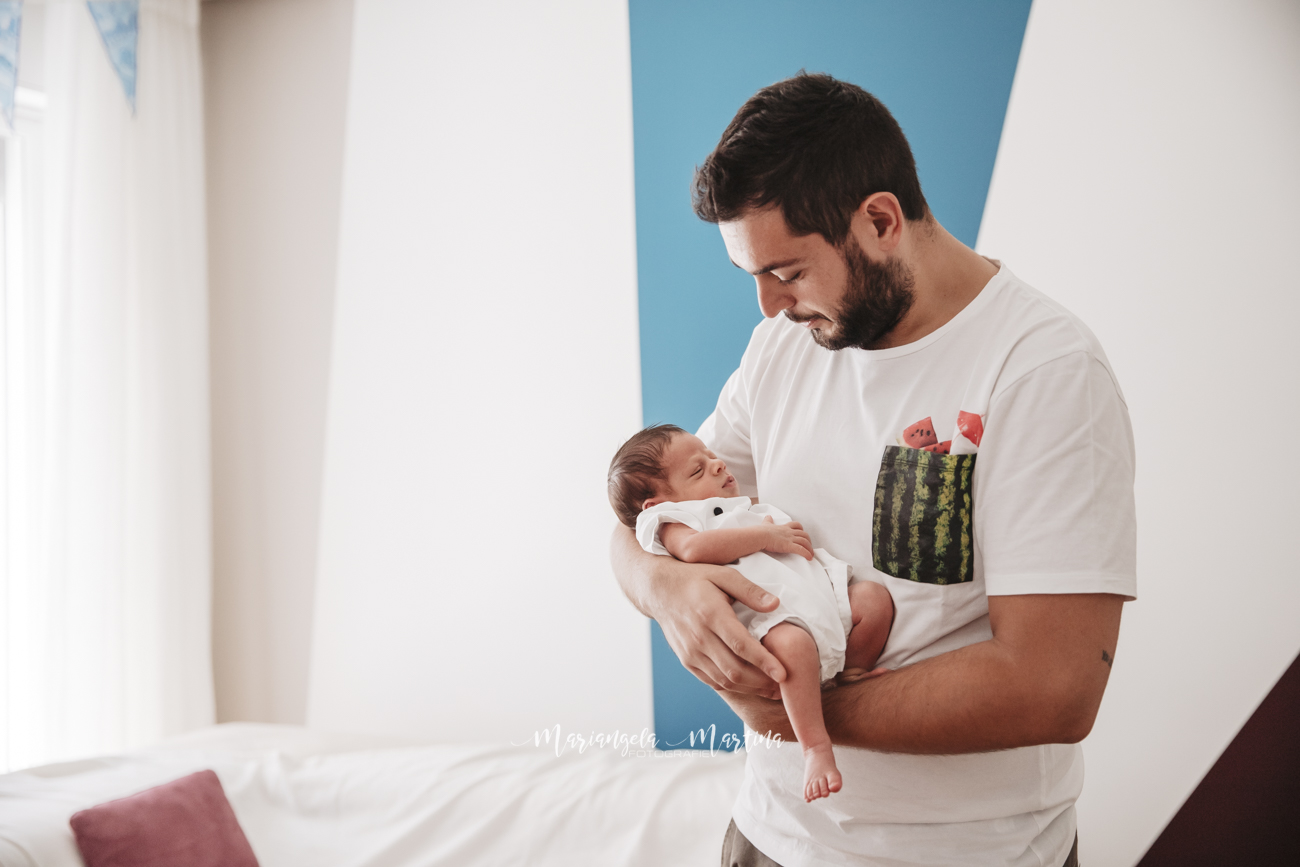 neonato che dorme tra e braccia di papà